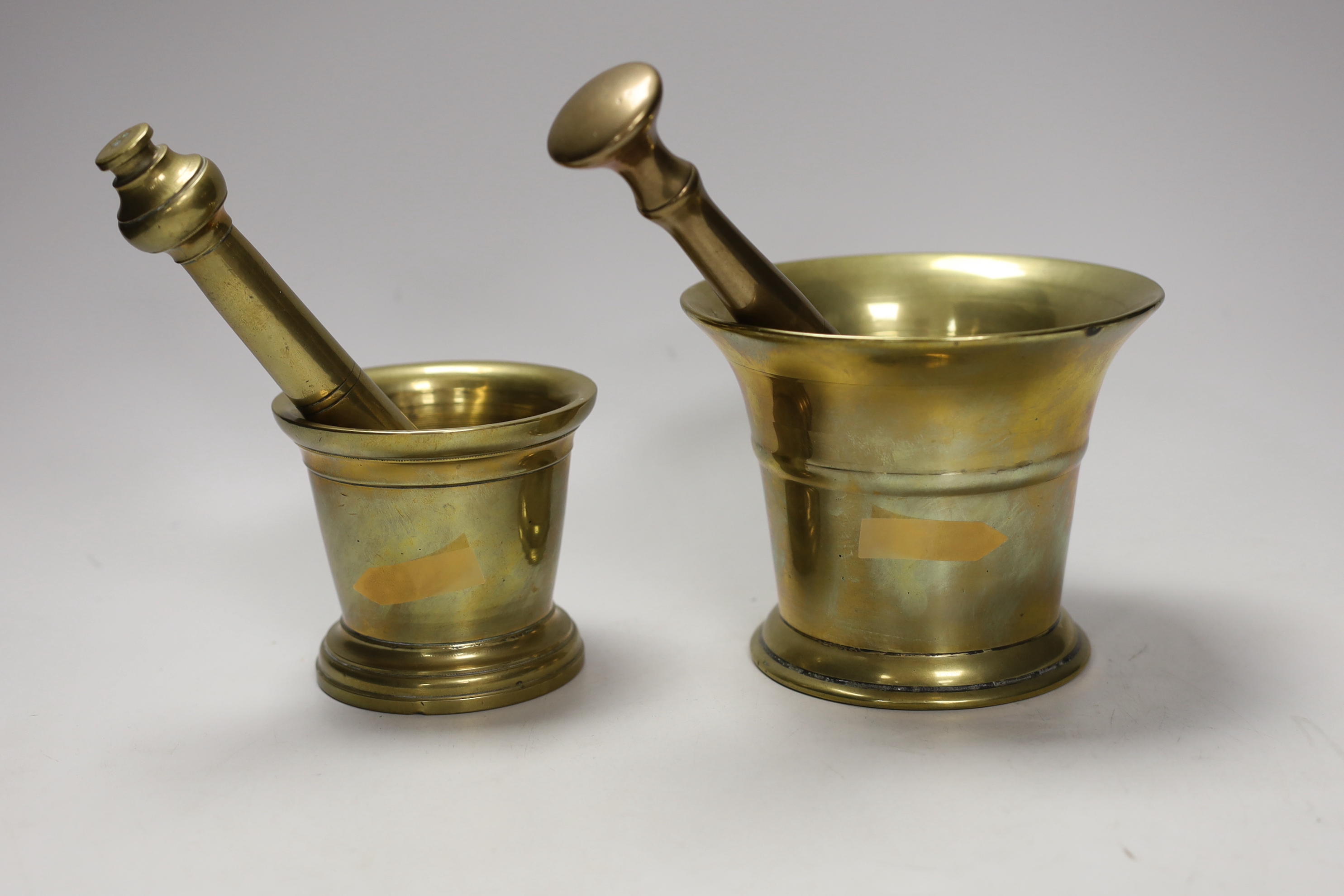 Two brass pestle and mortars, largest mortar 11.5cm tall